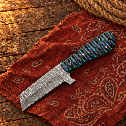 Blue-green Damascus knife overhead on a Western bandana