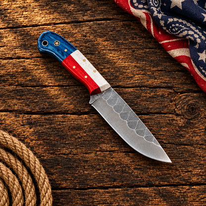 Red-white-blue cowboy knife on a weathered ranch surface